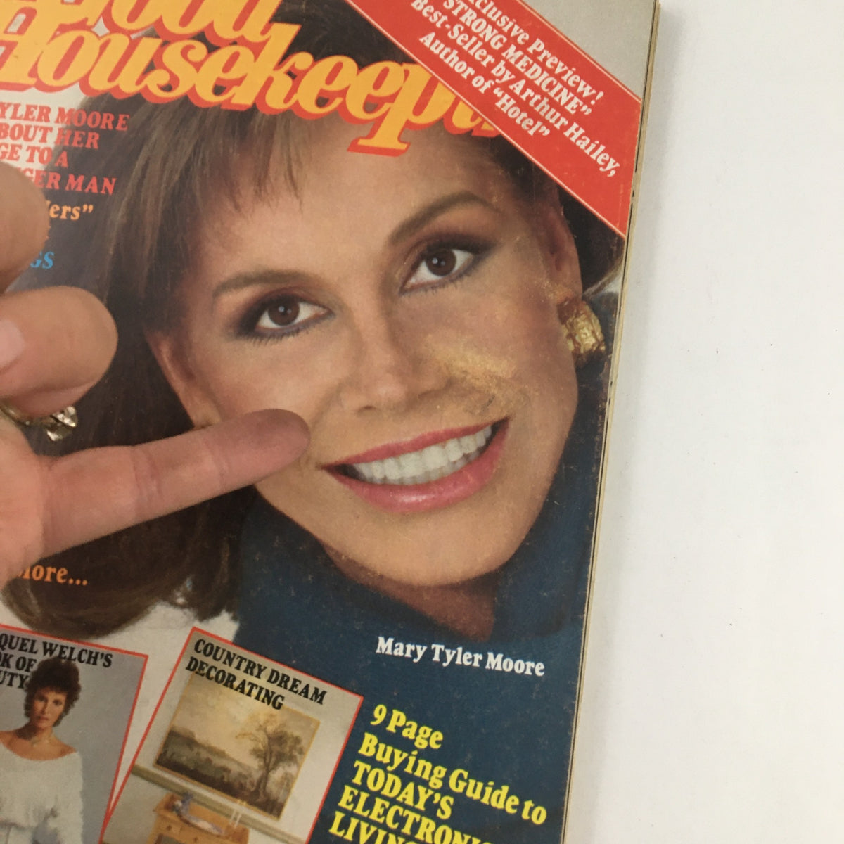 Close-up of the cover of Good Housekeeping Magazine, October 1984, with a finger pointing to Mary Tyler Moore's image. The magazine addresses her marriage and highlights other featured articles.