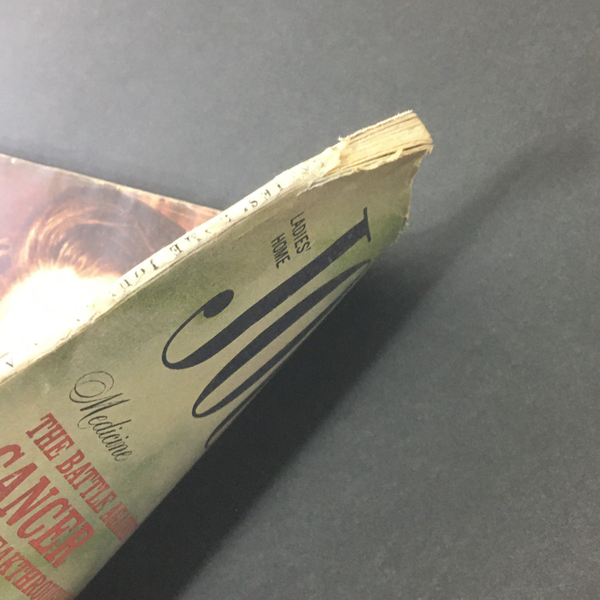 Side view of the VTG Journal Magazine August 1964 displaying signs of wear, including slightly worn edges of the magazine cover, emphasizing its vintage character.