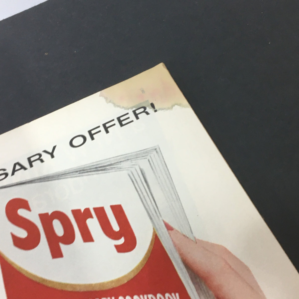Corner detail of the VTG Journal Magazine September 1955, featuring an advertisement for Spry and signs of wear.