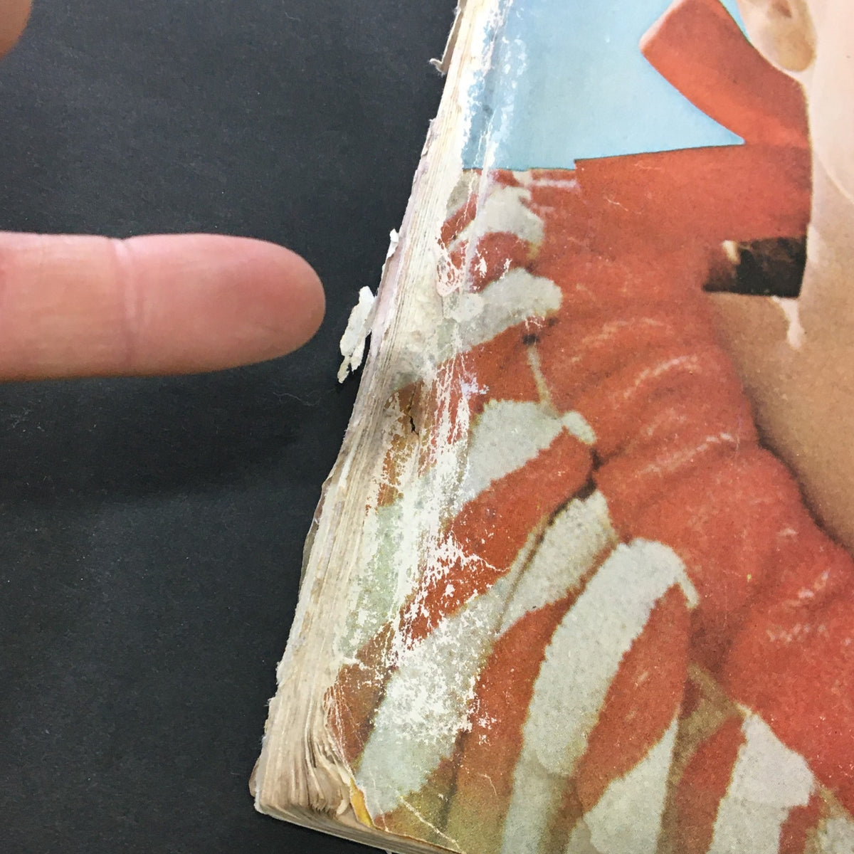 Detailed view of the side of the VTG Journal Magazine July 1964 showing signs of wear, including a rip and age-related discoloration.