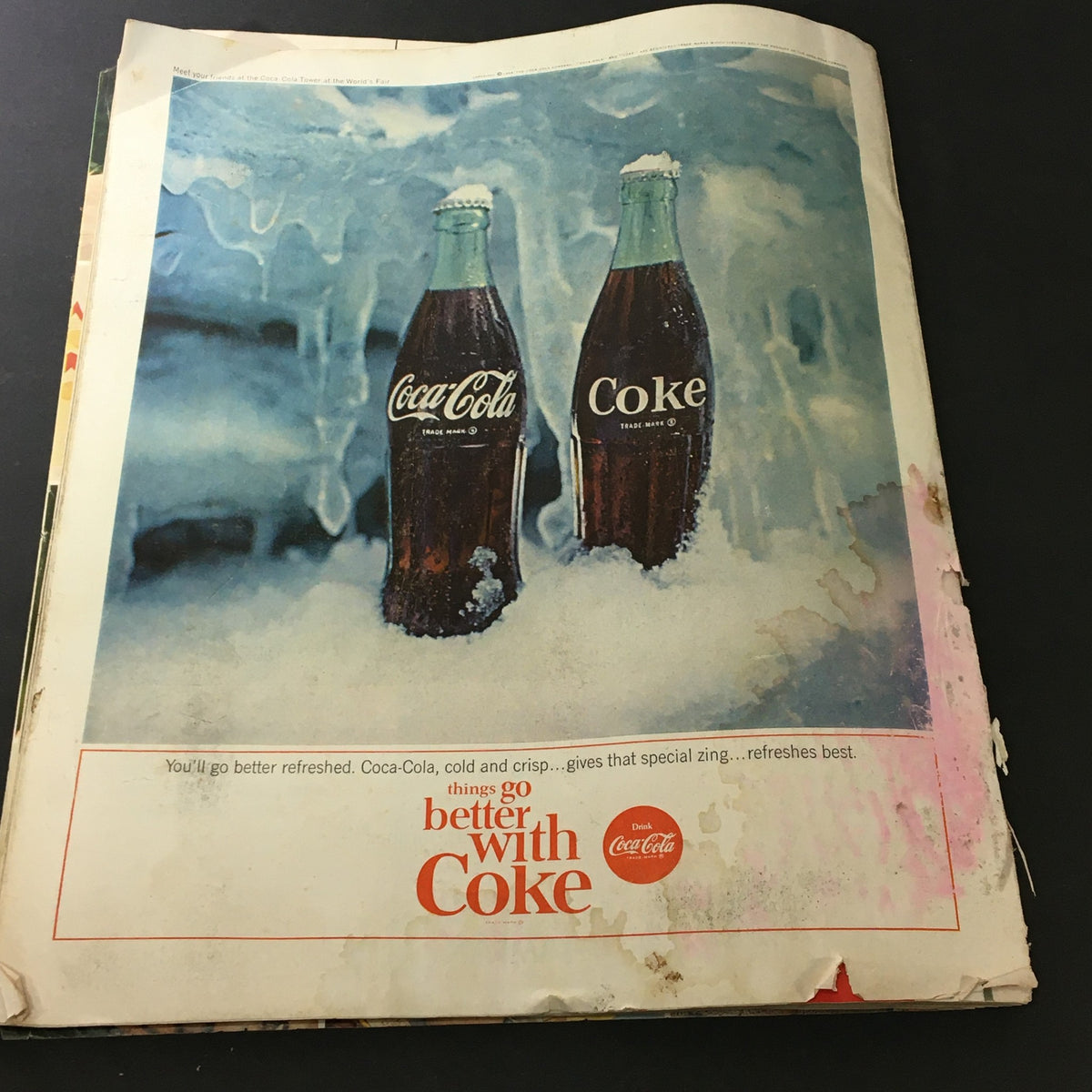 Vintage advertisement from VTG Journal Magazine July 1964 featuring Coca-Cola bottles in a frosty setting with the caption 'Things go better with Coke'.