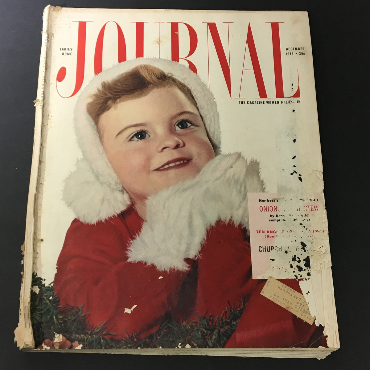 VTG Journal Magazine December 1954 featuring a smiling child in a Santa hat on the cover, showcasing vintage holiday themes.
