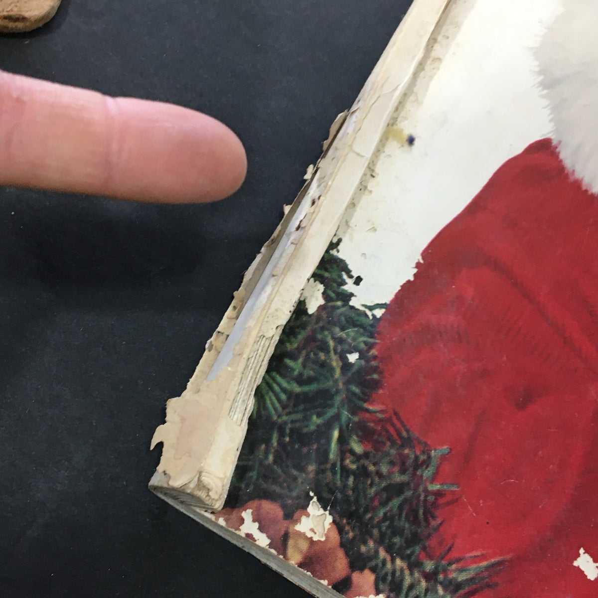 Side view of the VTG Journal Magazine December 1954 highlighting wear and tear, showcasing the vintage character of the magazine.