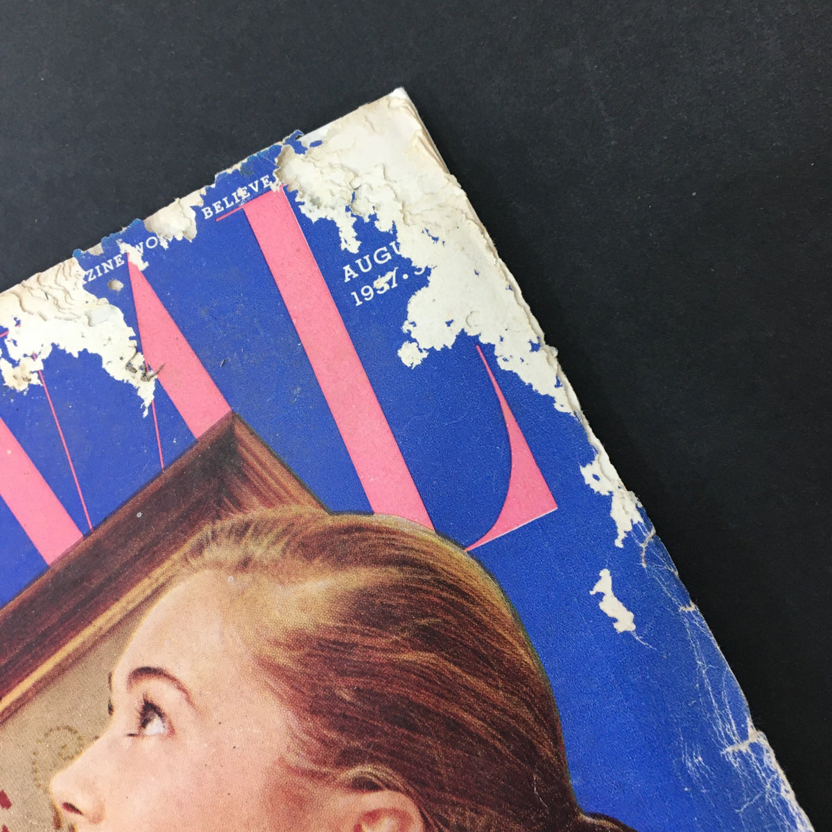 Top corner of the cover of VTG Journal Magazine August 1957, displaying significant wear and fraying, illustrating the magazine's age and vintage character.
