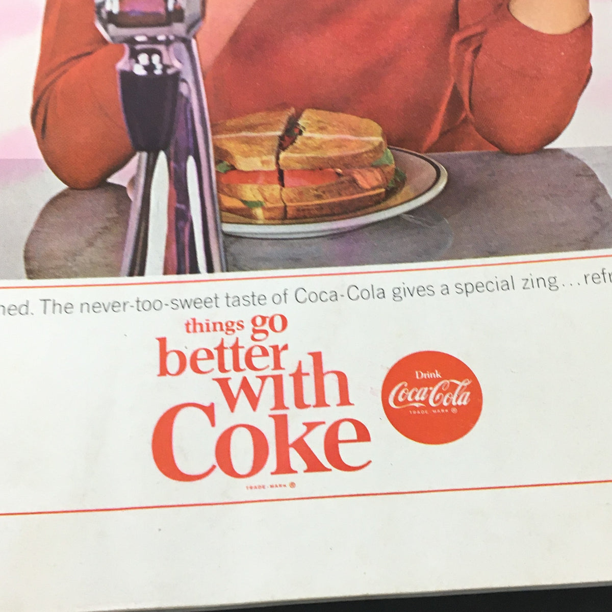 Close-up of the Coca-Cola advertisement on the back of VTG Journal Magazine March 1964, showcasing a catchy slogan and product.
