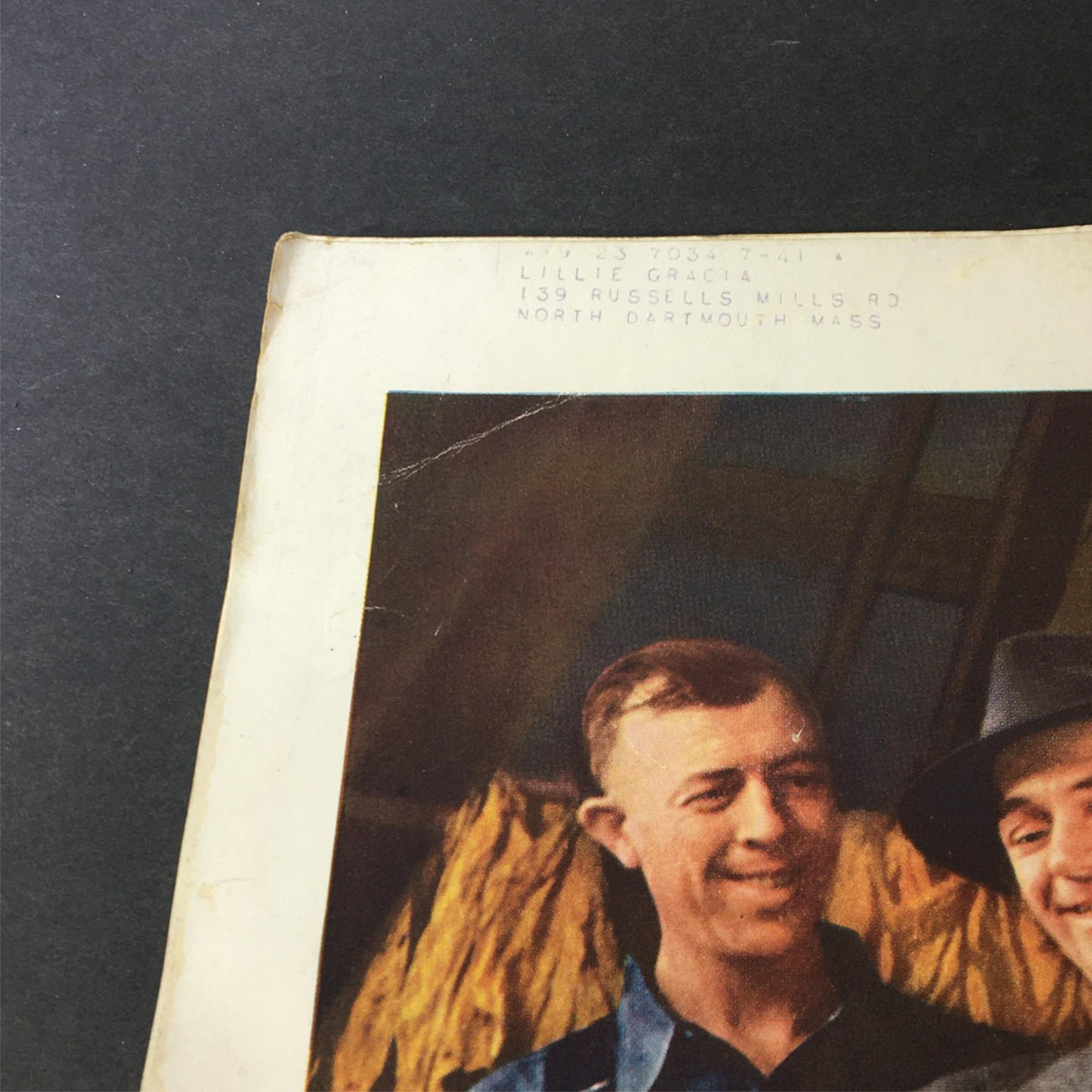 Close-up of the tobacco advertisement from VTG Better Homes & Gardens June 1940, showcasing two men and a woman highlighting tobacco leaves, with a focus on the character smiling.