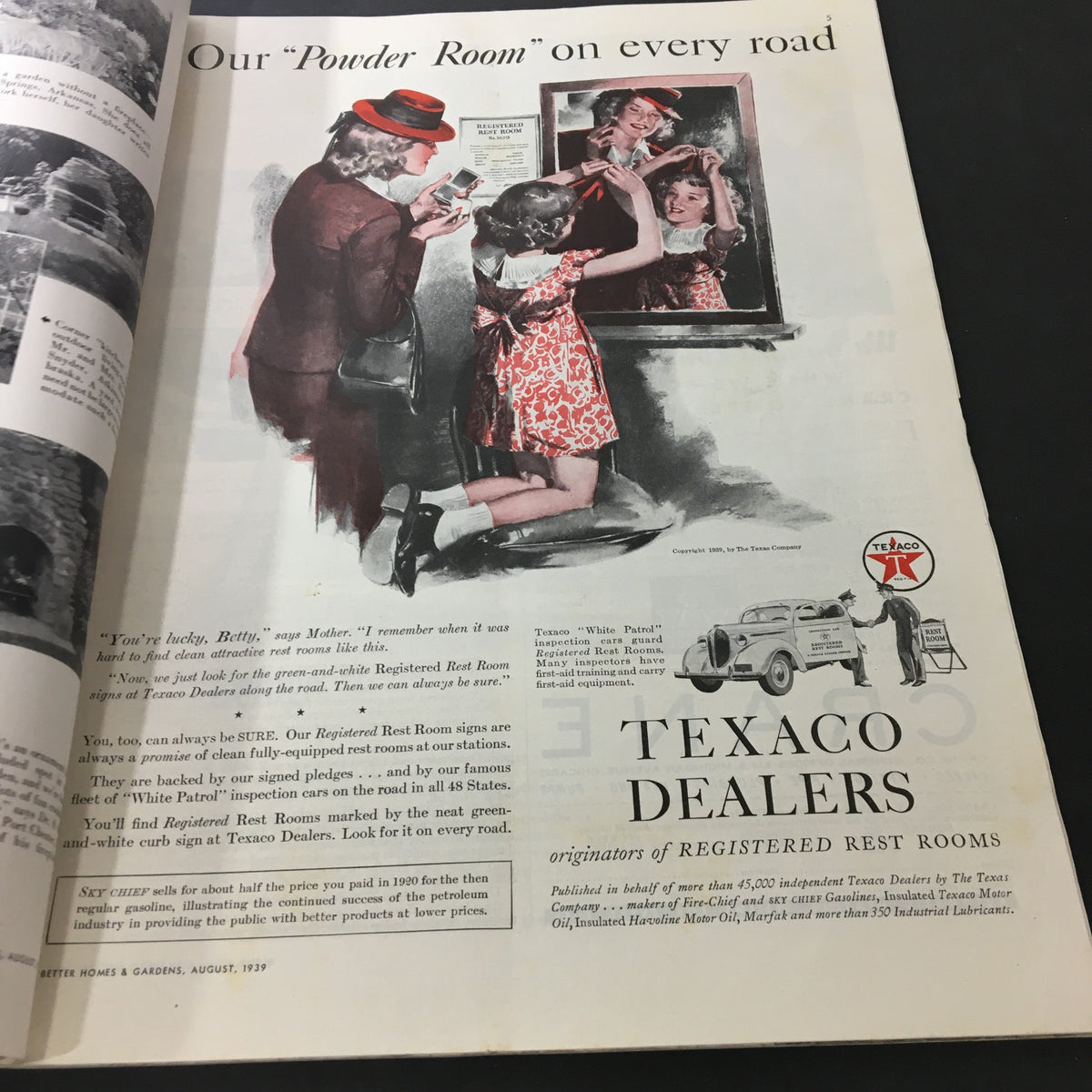 Advertisement from VTG Better Homes & Gardens August 1939 Vol 17 #12 featuring a scene of women in a powder room with a Texaco dealer, promoting cleanliness and comfort while traveling.