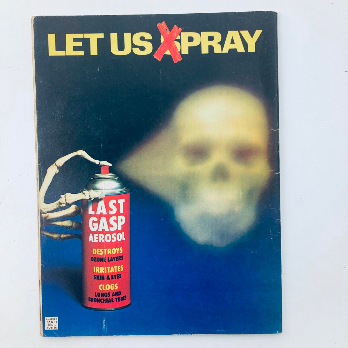 Cover of VTG Mad Magazine October 1976 No. 186, featuring a humorous depiction of a spray can and eerie skull, reflecting the magazine's satirical style.