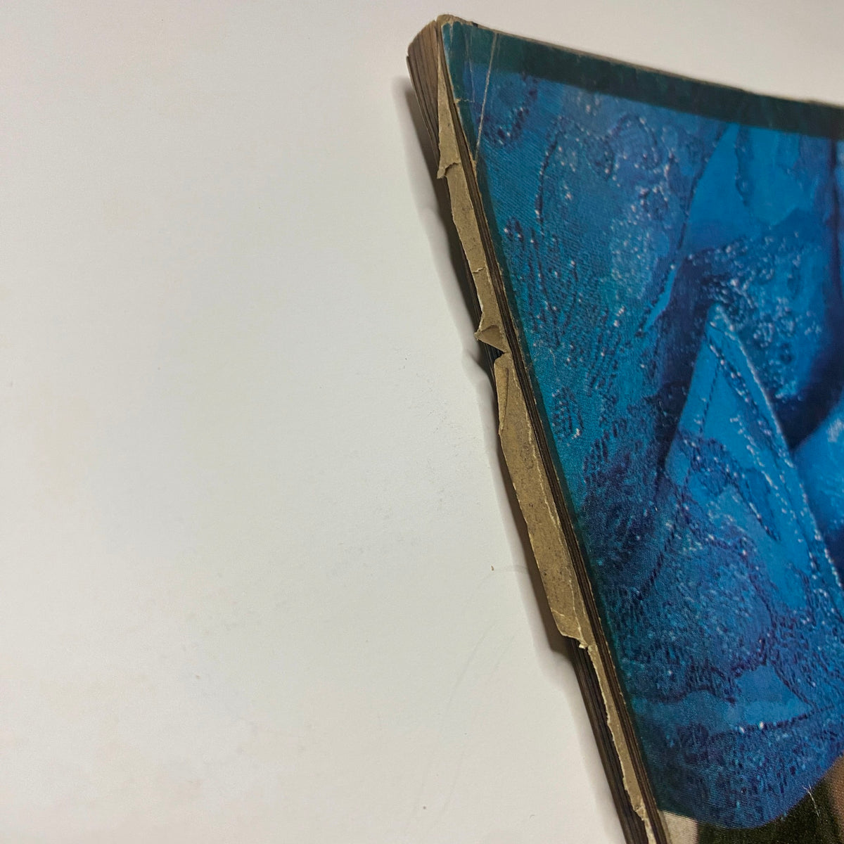 Close-up view of the spine of Vogue Magazine September 15, 1969 Susanne Schöneborn Cover, showing wear and creases indicative of its vintage condition.