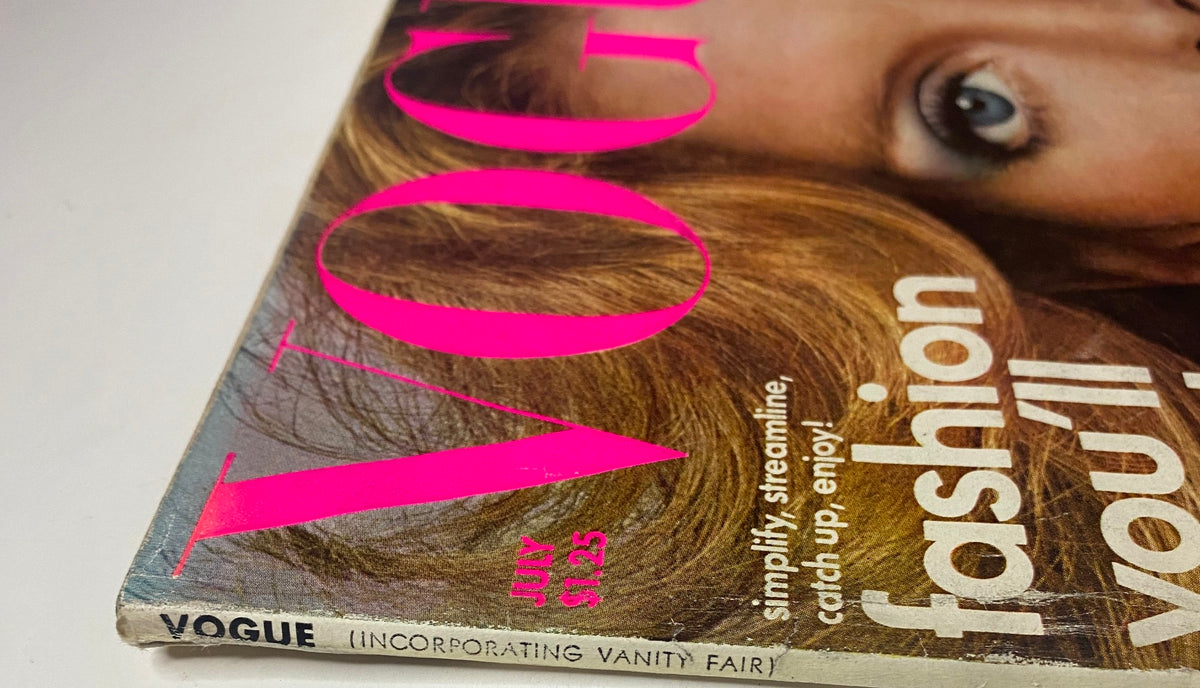Close-up of the July 1975 issue of Vogue Magazine featuring Rene Russo on the cover, highlighting the vibrant pink text and iconic design.