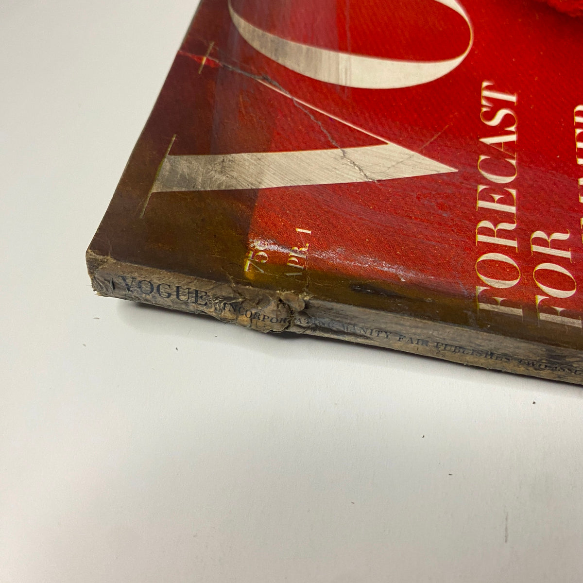 Detailed close-up of the spine of Vogue Magazine April 1, 1965, showing minor wear and aging consistent with vintage publications.
