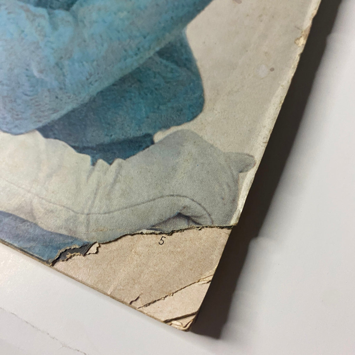 Close-up of the edge damage on the cover of Vogue Magazine August 15, 1963 featuring Wilhelmina Cooper, showcasing vintage wear.