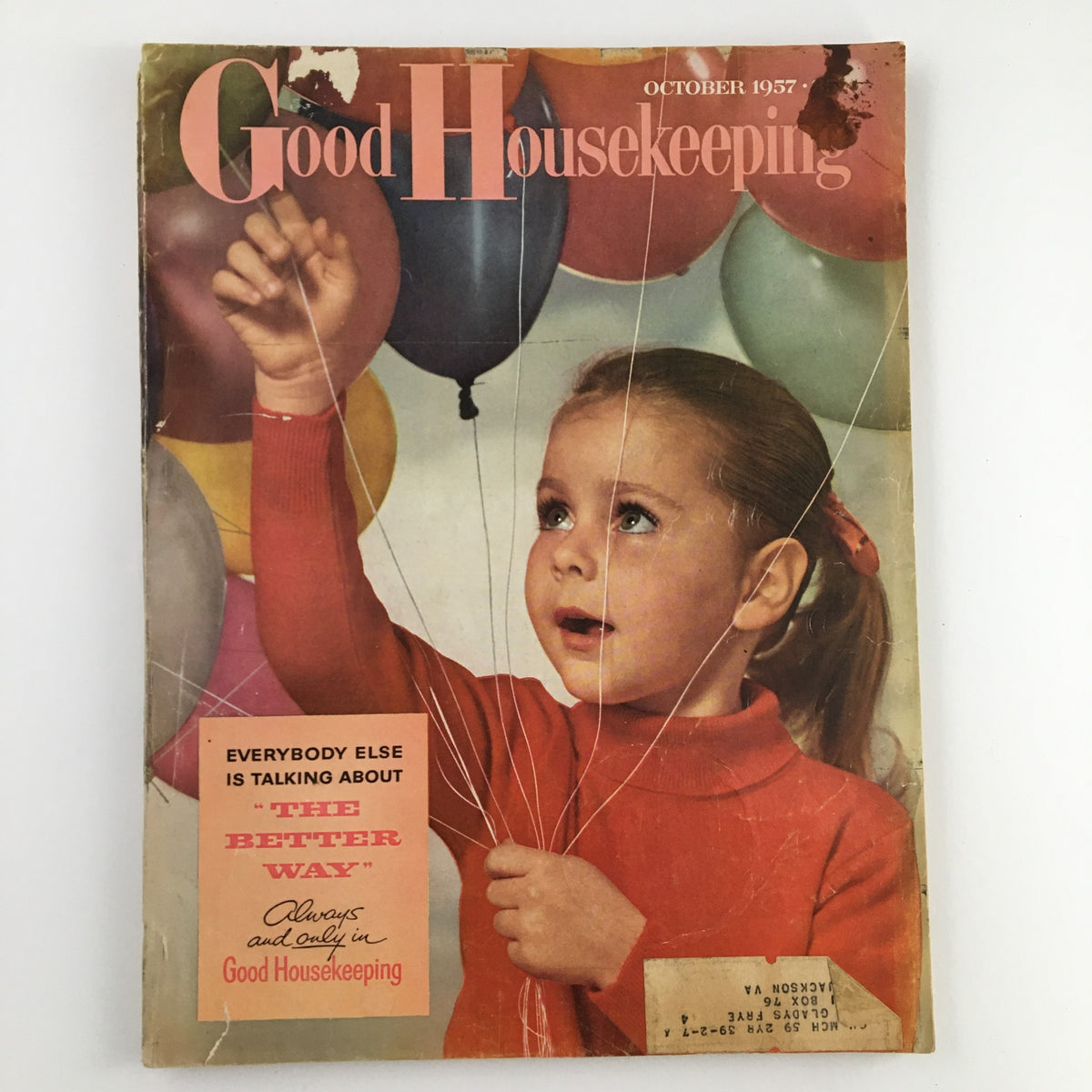 Cover of Good Housekeeping Magazine, October 1957, featuring a young girl holding balloons, capturing the essence of the late 1950s home life and trends.