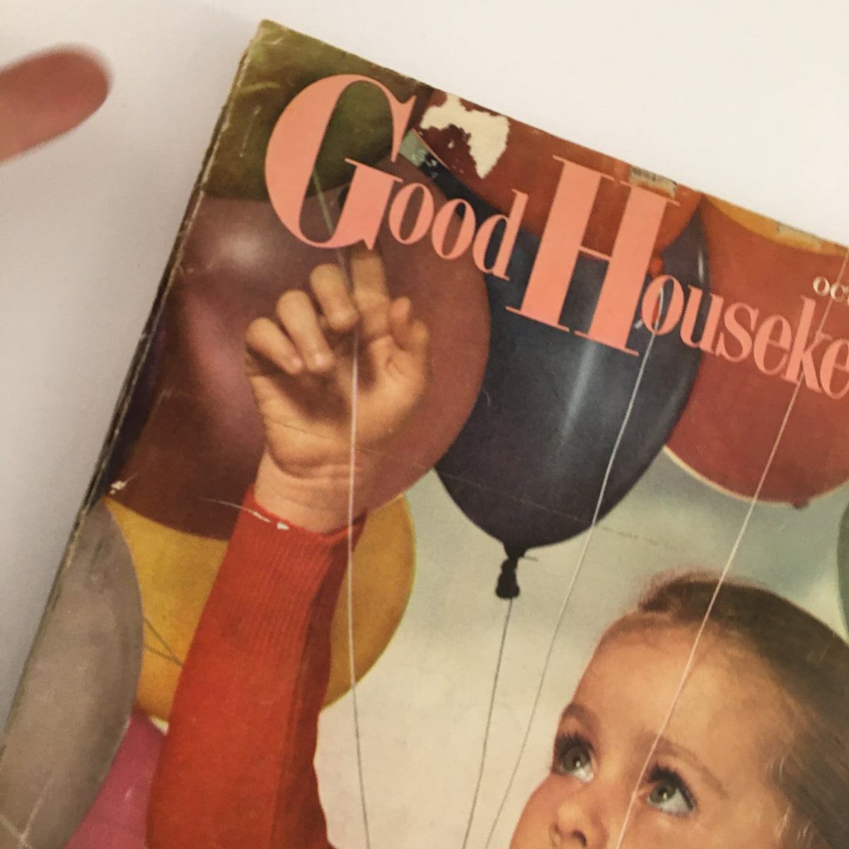 Cover of Good Housekeeping Magazine October 1957 featuring a child holding colorful balloons and showcasing the issue's title, 'Everybody Talking About The Better Way.'