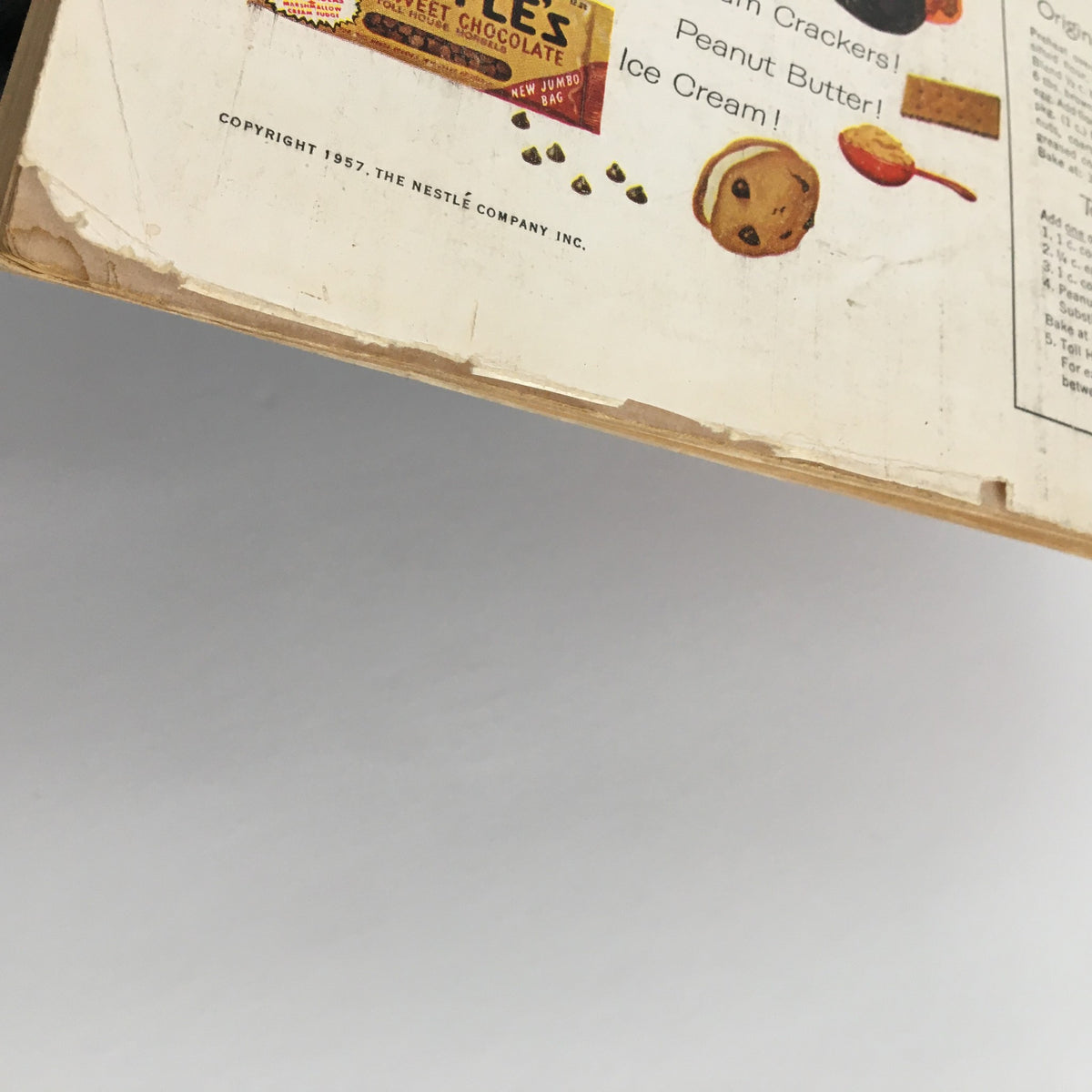 Side view of the back cover of Good Housekeeping Magazine October 1957 showing the Nestle's Toll House advertisement, emphasizing classic cookie recipes and ingredients.