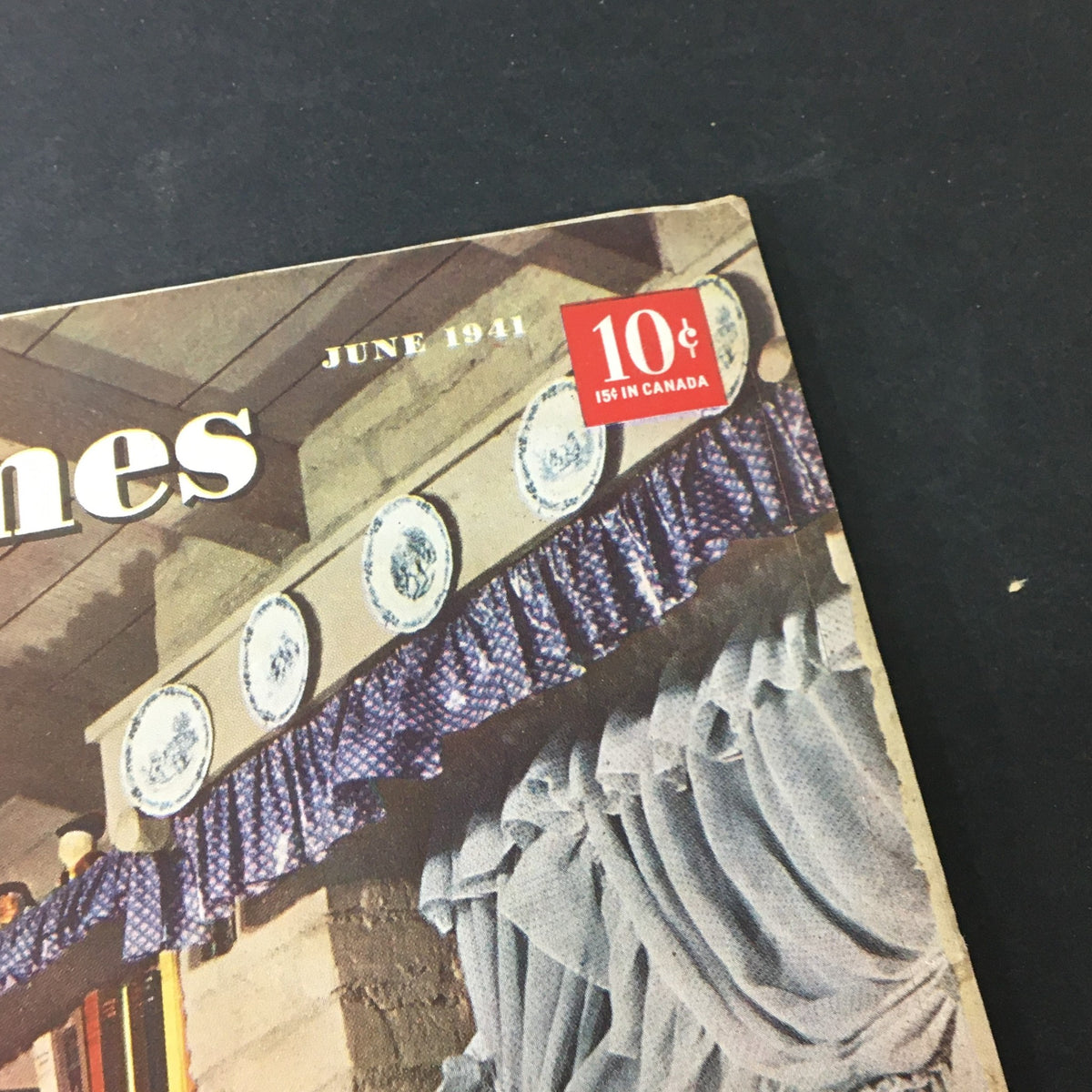 Close-up of Better Homes & Gardens June 1941 magazine cover highlighting the publication date and price with vintage plate decoration on the top shelf.