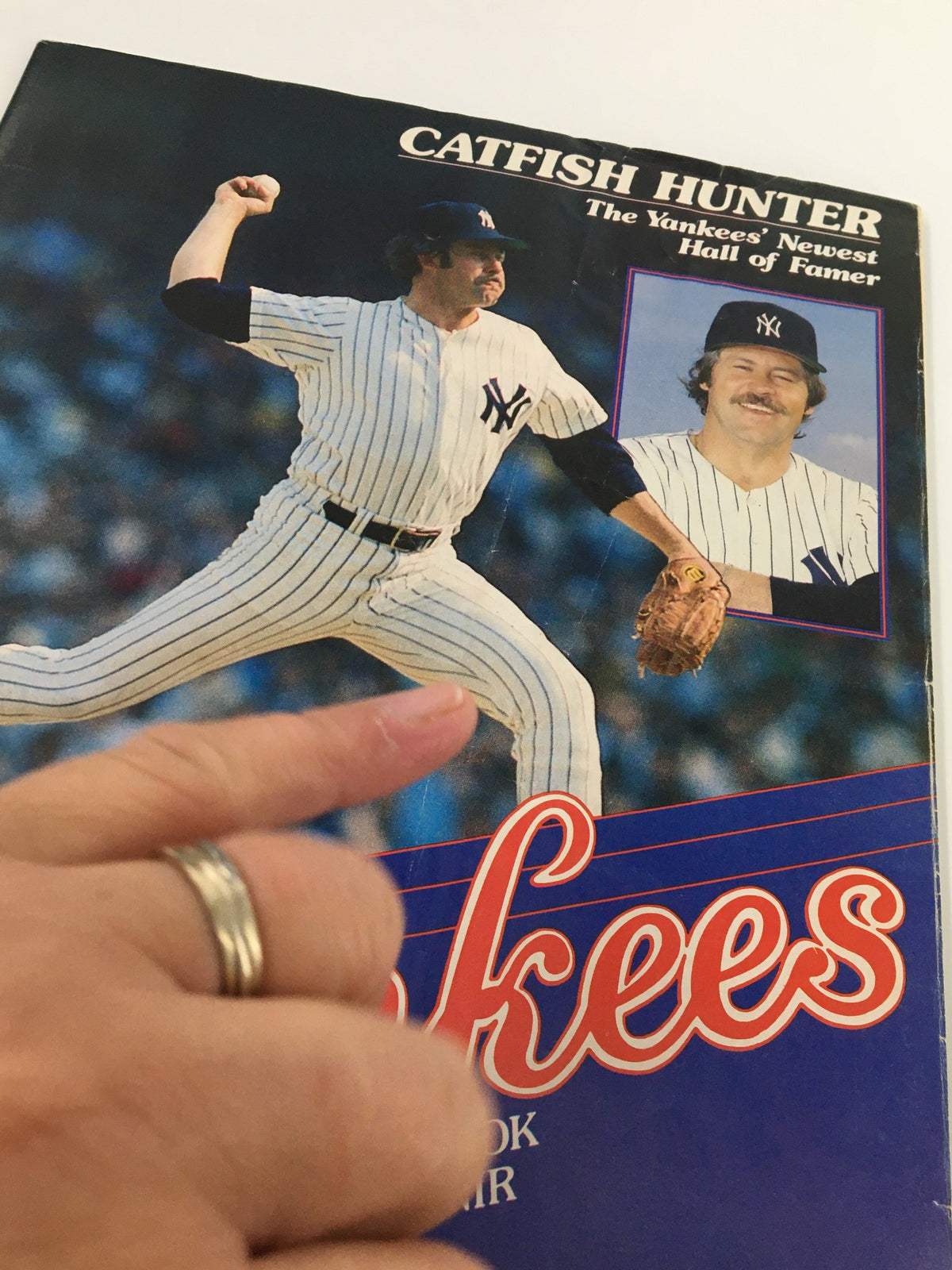 Close-up of the 1987 Official Scorebook & Souvenir Program for the MLB New York Yankees, highlighting Catfish Hunter in action and featuring an image of him alongside the title.