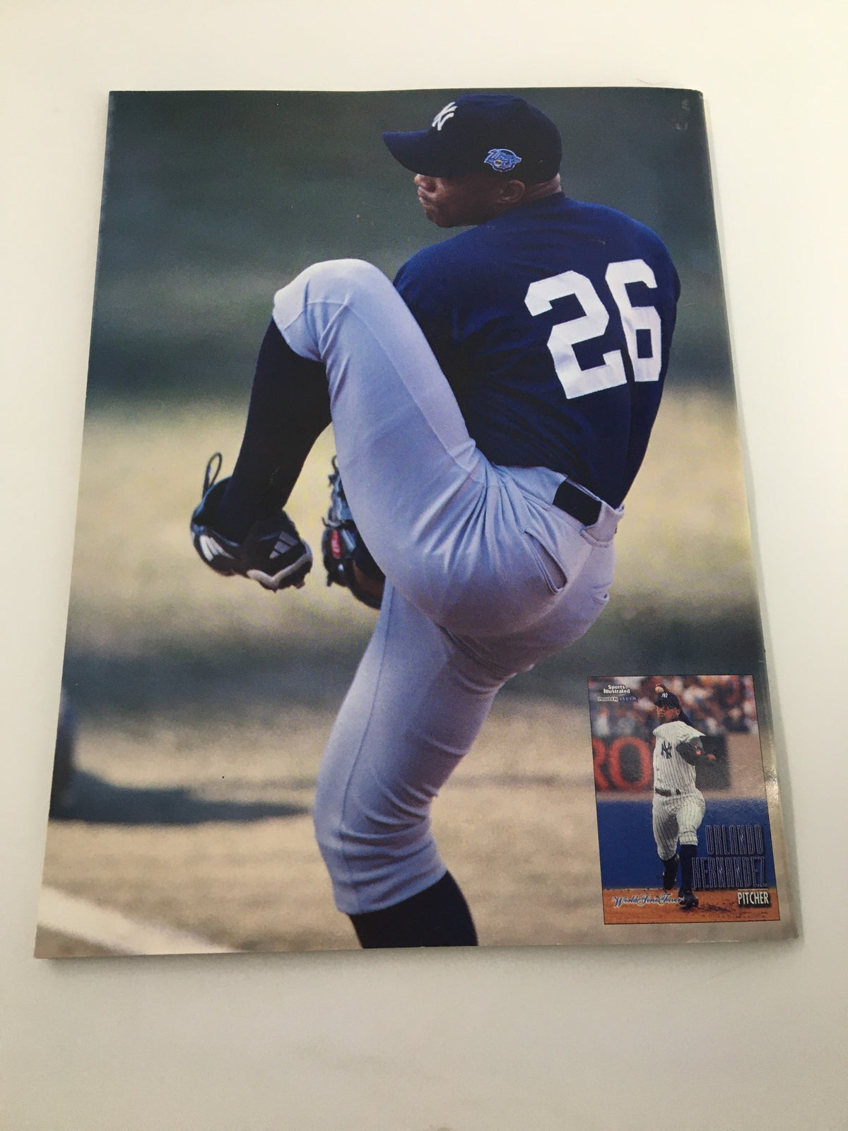 Image of a baseball player from Beckett Baseball Card Monthly January 1999 #166, showcasing Orlando Hernandez in action, accompanied by a card image, emphasizing the publication's focus on player highlights.