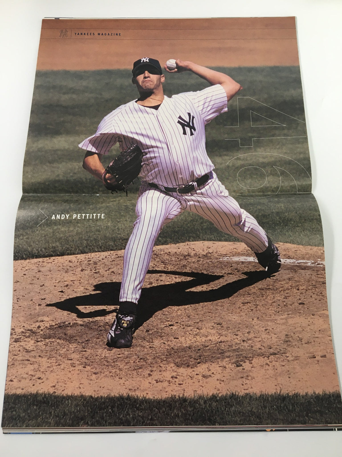 Centerfold poster from Yankees Magazine, April 2003, showcasing pitcher Andy Pettitte in action on the mound, as a highlight of the issue.