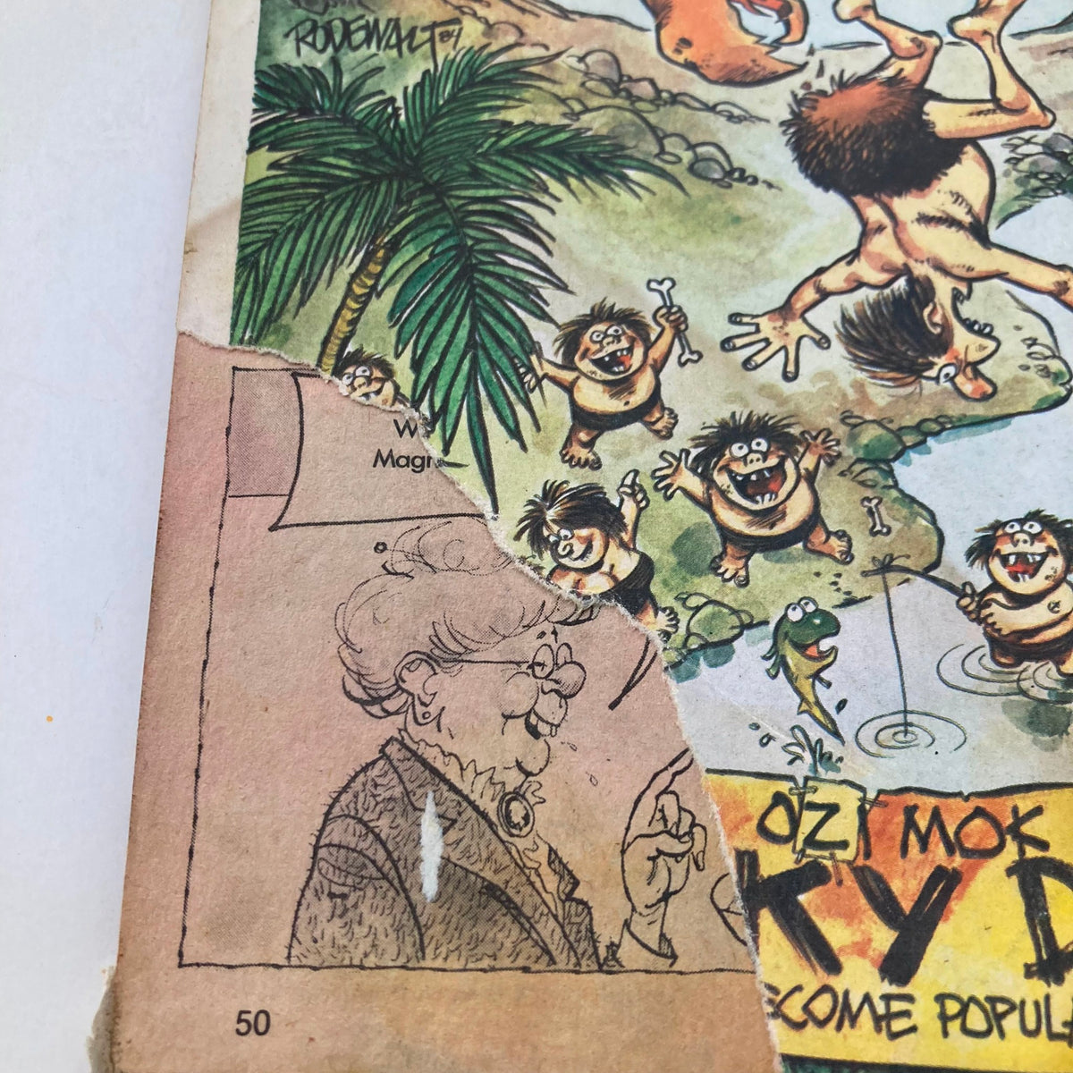 Close-up of the Cracked Magazine October 1984 No. 207, featuring a humorous cartoon illustration and a damaged edge, showcasing the vintage condition of this collectible magazine with Michael Jackson on the cover.
