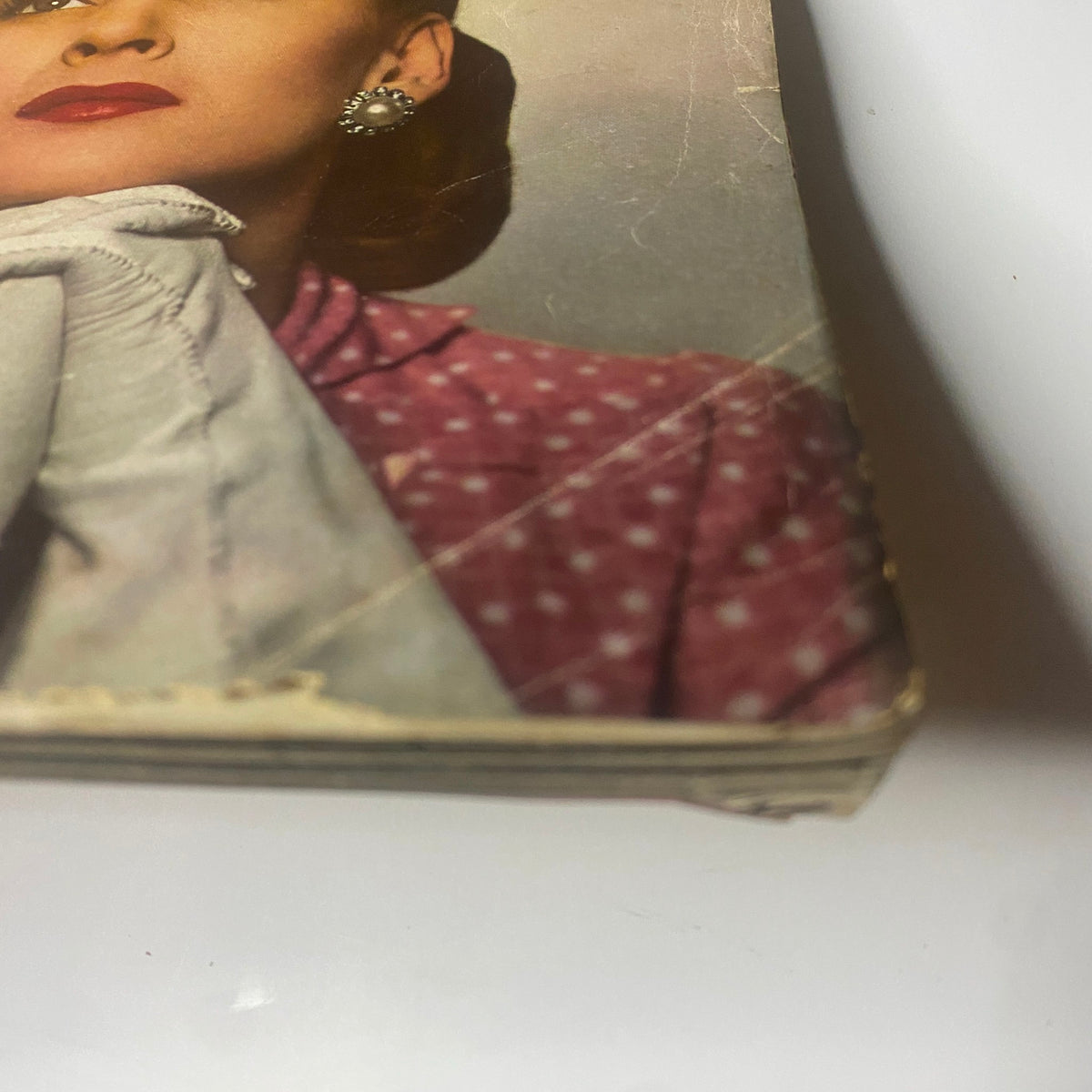 Close-up of the cover of Harper's Bazaar Magazine May 1944 by Louise Dahl-Wolfe, highlighting a pink polka dot outfit worn by a female model.