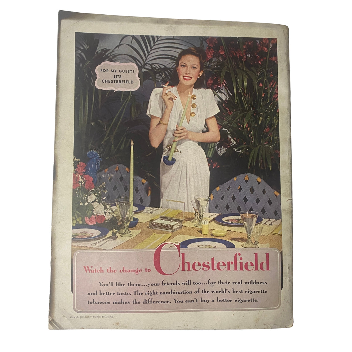Cover of Harper's Bazaar Magazine May 1944 advertising Chesterfield cigarettes, featuring a stylish woman at a dining table, embodying mid-20th century elegance.