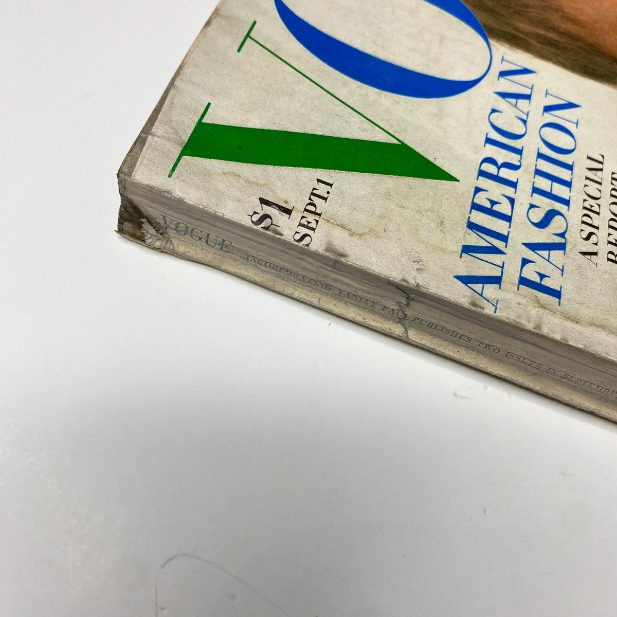 Close-up of the spine of Vogue Magazine September 1, 1969 showing signs of wear and age, while retaining the title and features of American fashion and the New York Collections.