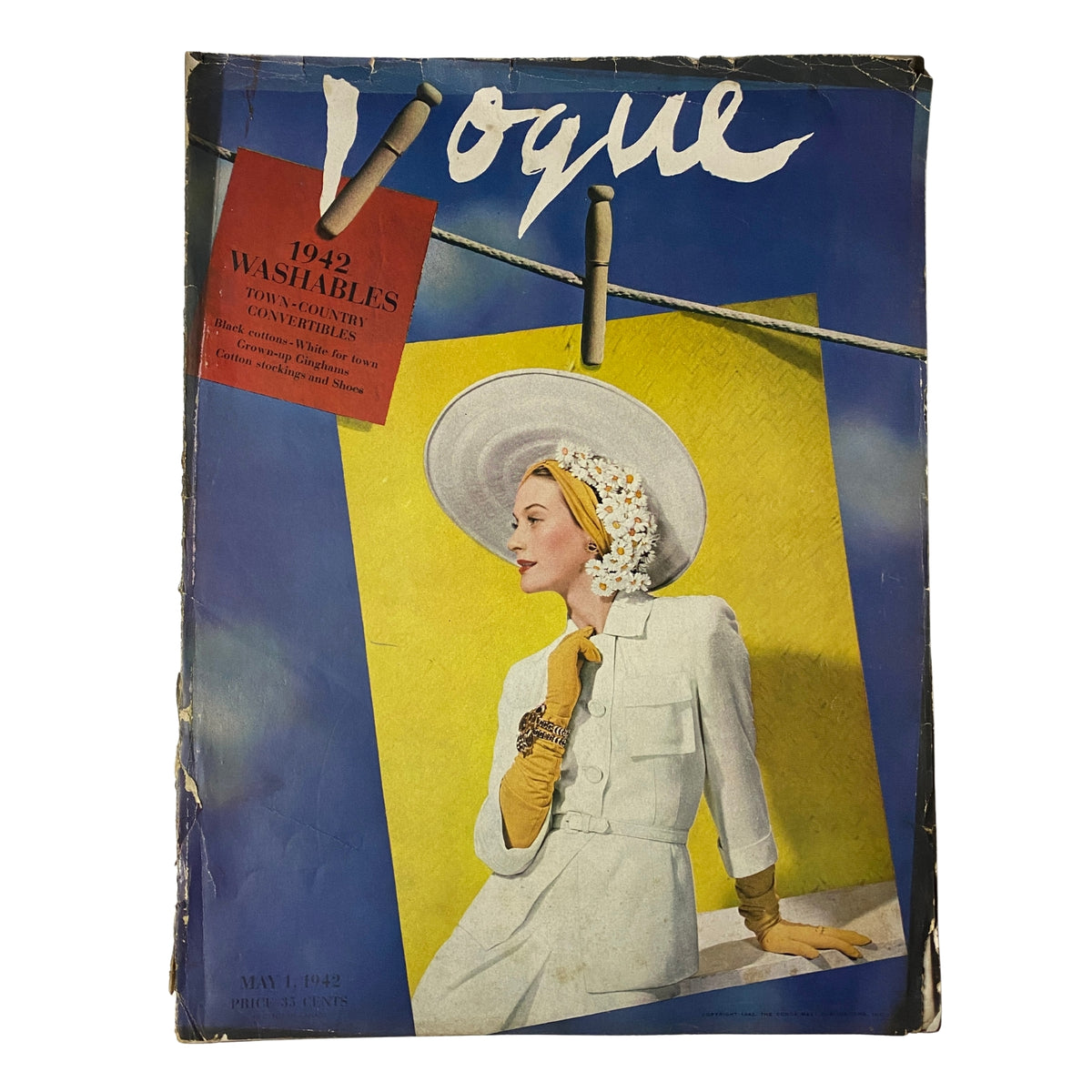 Vogue Magazine May 1, 1942 featuring a cover photograph of Dana Jenney by John Rawlings. The cover showcases a stylish model in a white outfit accessorized with yellow gloves and a wide-brimmed hat, reflecting early 1940s fashion.