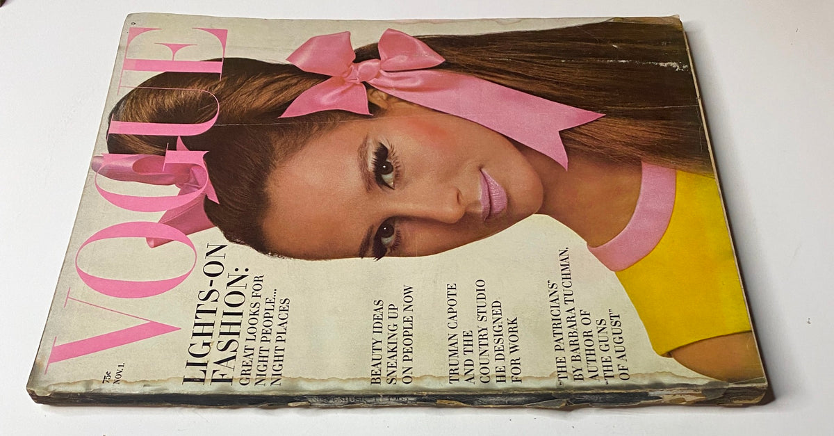 Vogue Magazine cover from November 1, 1965 showcasing Brigitte Bauer by Irving Penn. The vibrant cover presents a stylish model wearing a yellow dress with a pink bow, highlighting 'Lights-On Fashion' for nighttime elegance.