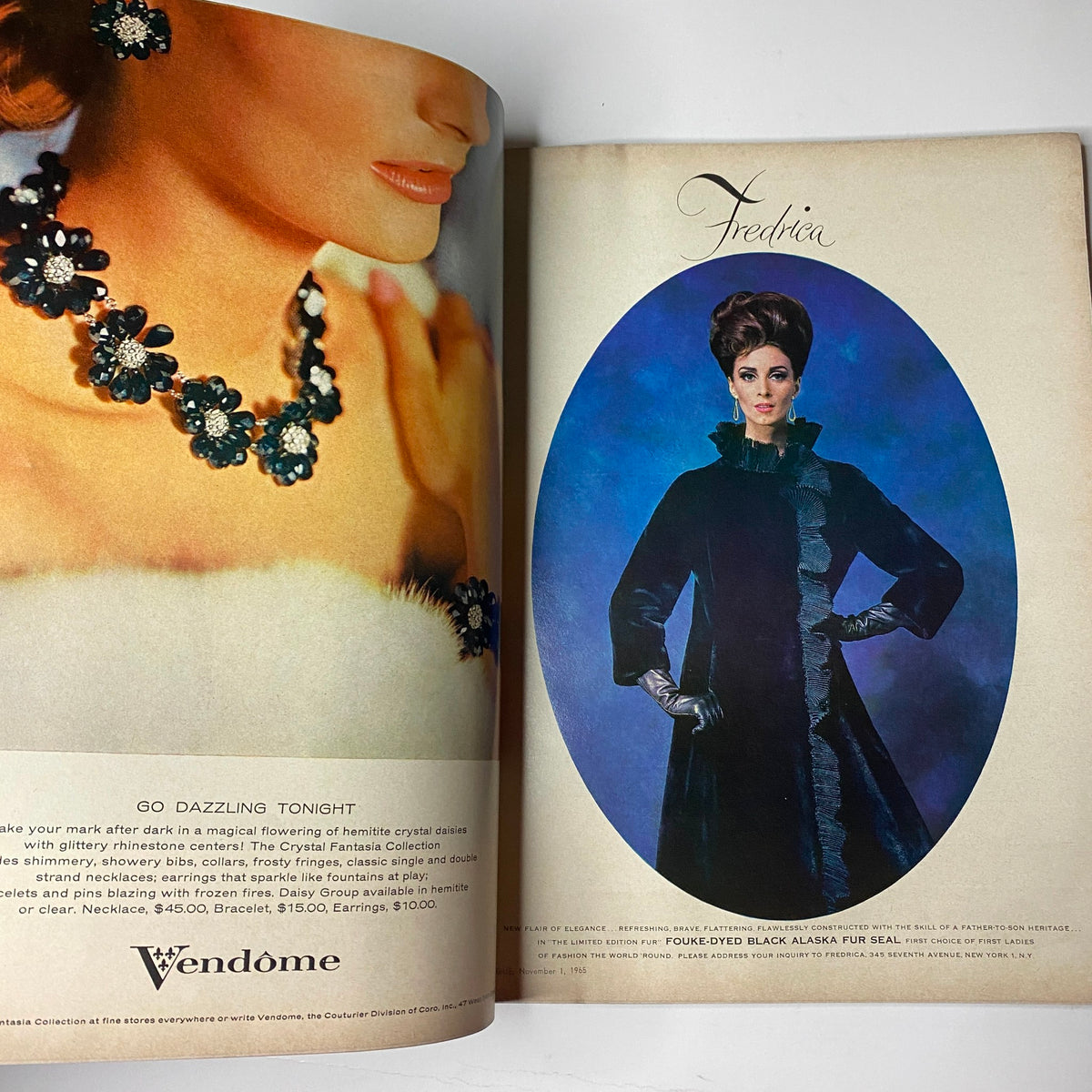 Vogue Magazine November 1, 1965 featuring an advertisement with a model in elegant jewelry and a stylish fur coat, representing classic elegance.