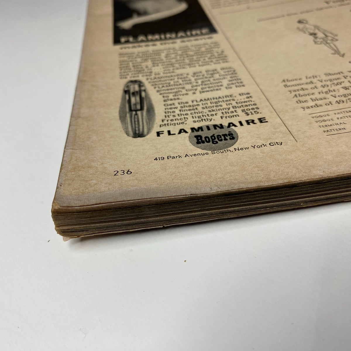 Vintage detail of Vogue Magazine November 1, 1965 featuring Brigitte Bauer cover by Irving Penn, showcasing pages with age-related wear and visible spine elements.