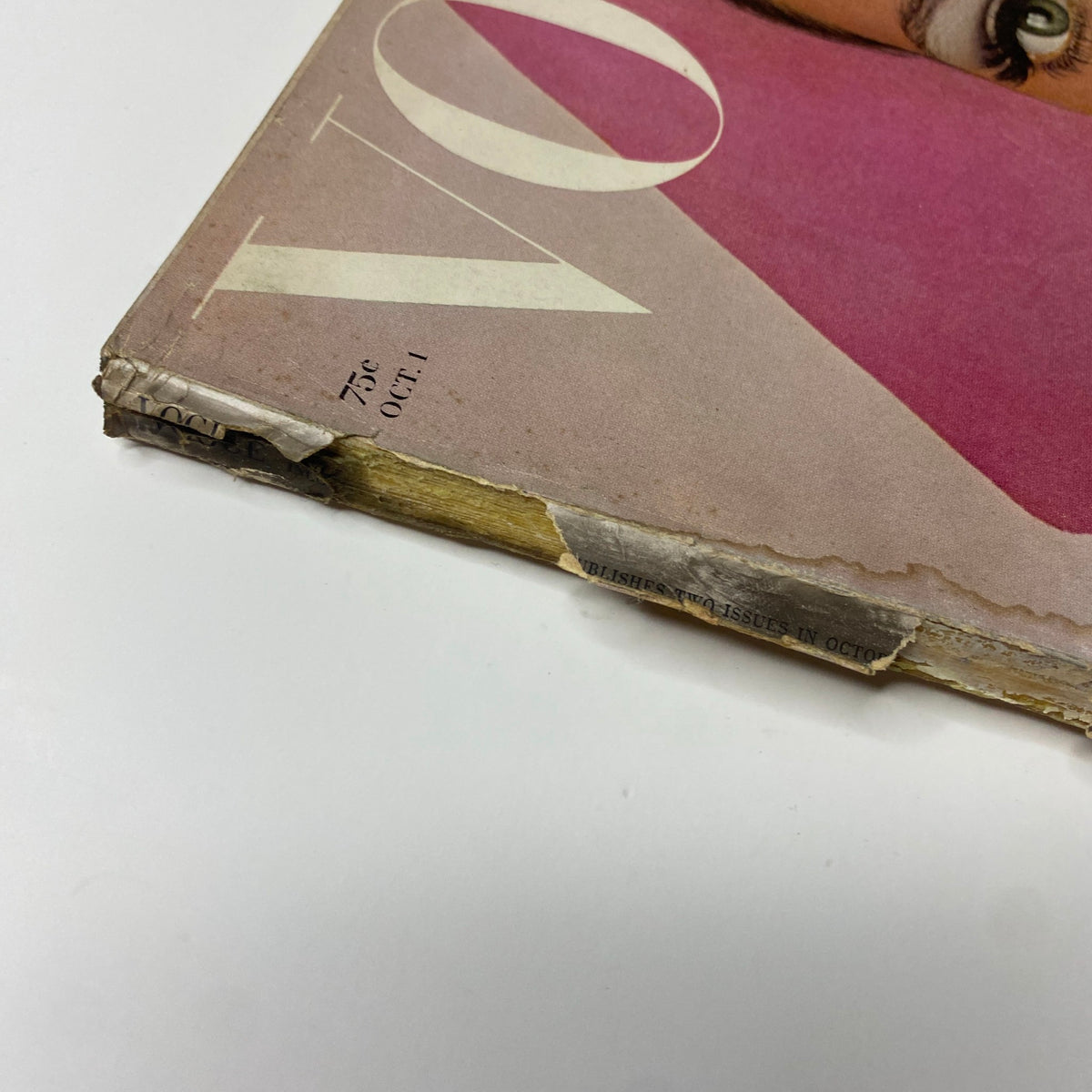 Side view of the October 1, 1965 Vogue Magazine, showcasing wear on the spine and corners, reflecting its vintage character.