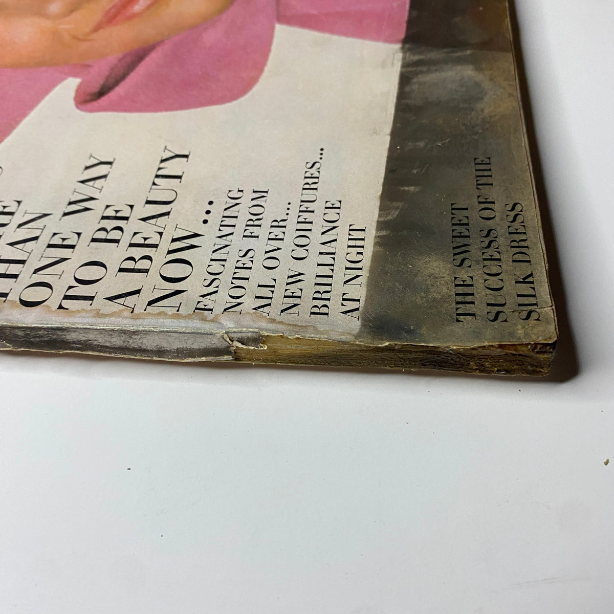 Close-up of the October 1, 1965 Vogue Magazine cover, emphasizing the headline about beauty and fashion trends with visible wear.