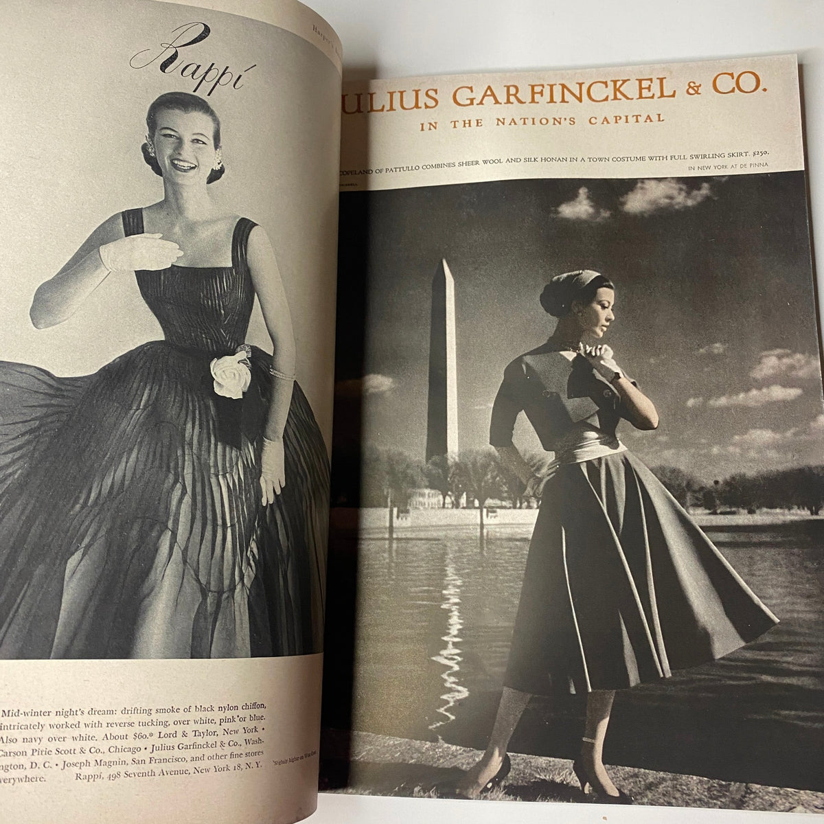 Fashion promotion page from Harper's Bazaar Magazine February 1955, displaying a stylish dress by Julius Garfinkle & Co. in front of a monument.
