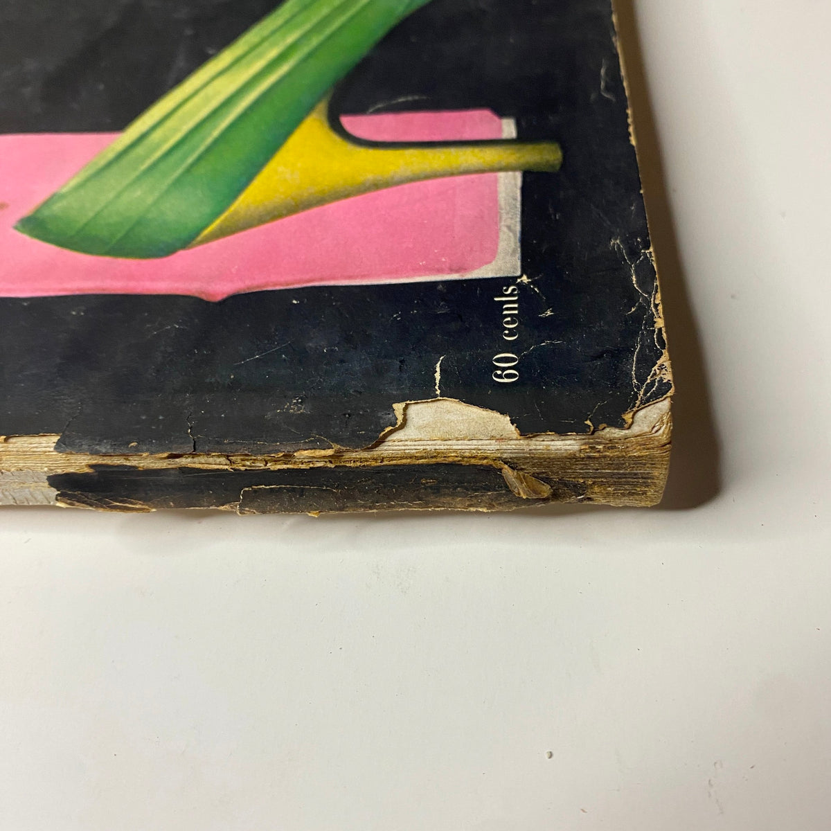 Close-up view of the spine and edge of Harper's Bazaar Magazine September 1955, showcasing wear and vintage aesthetic, emphasizing 'The American, Paris Openings' title.