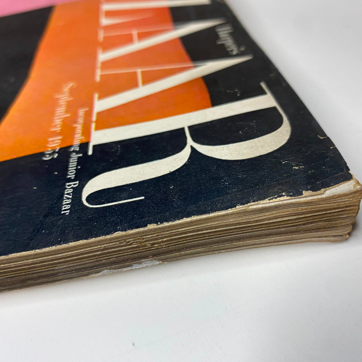 The spine view of Harper's Bazaar Magazine September 1955 revealing the age and wear of the publication.