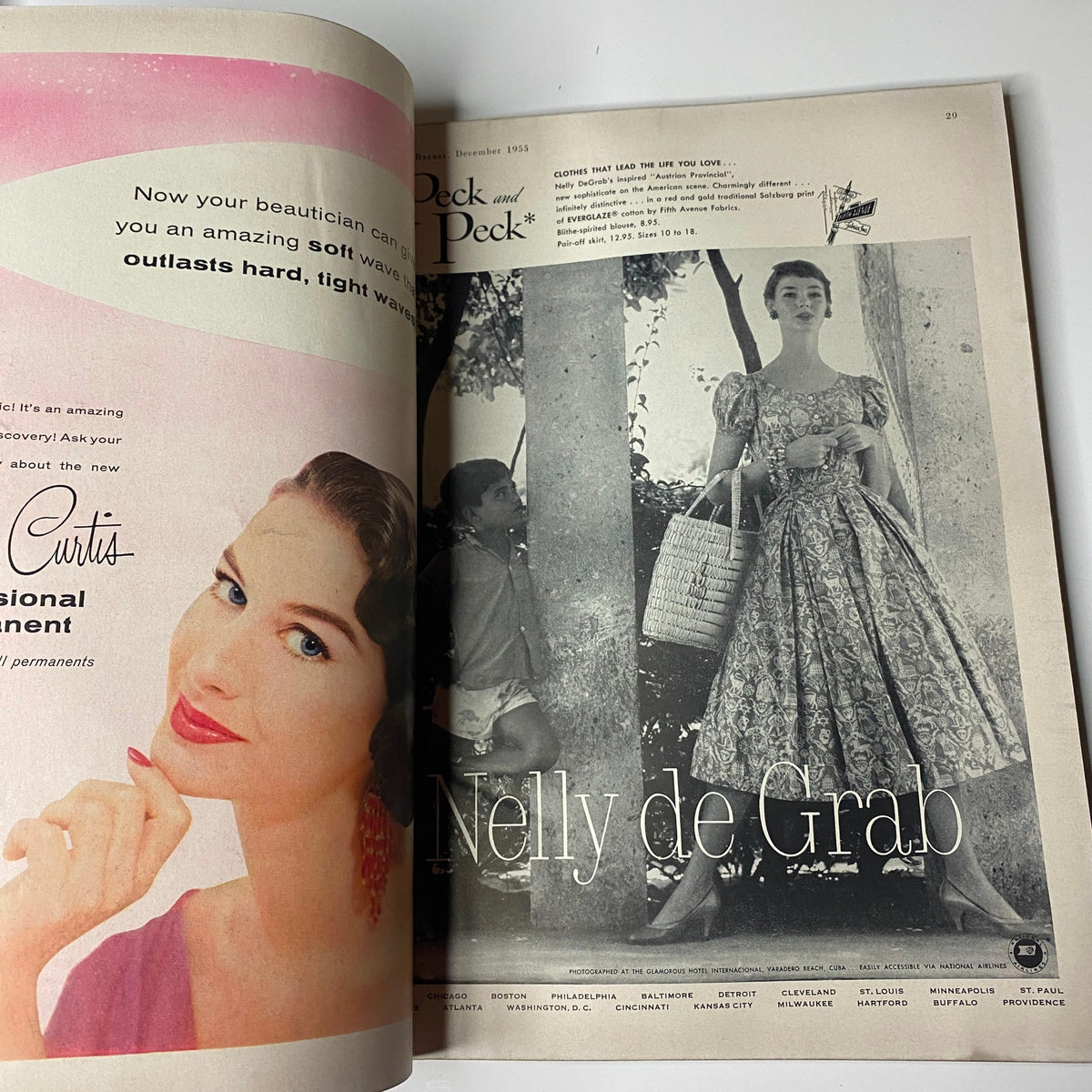 Harper's Bazaar Magazine December 1955 featuring an advertisement with a model promoting beauty products, highlighting vintage fashion.