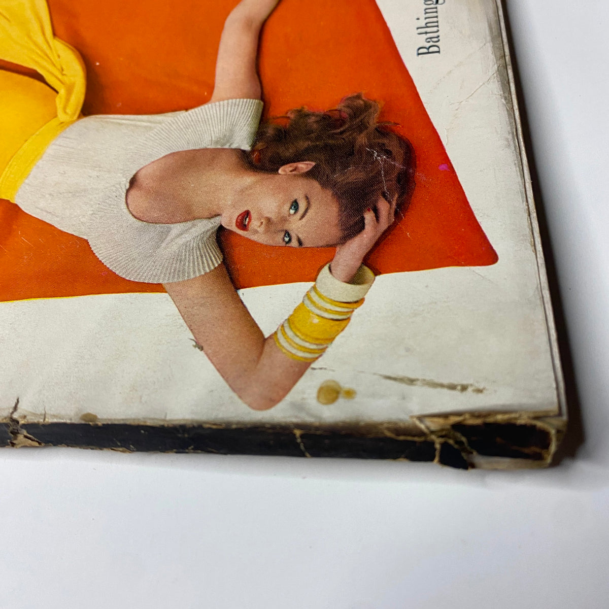 Cover image of Harper's Bazaar Magazine May 1955 featuring Suzy Parker in a stylish bathing suit against a vibrant background, photographed by Richard Avedon.