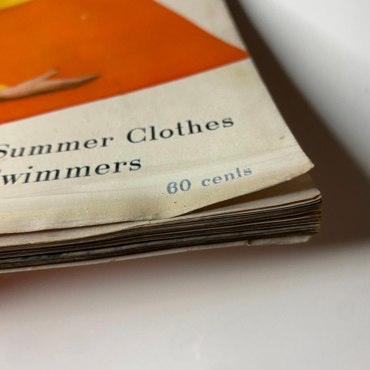 Vintage price detail from Harper's Bazaar Magazine May 1955, indicating 60 cents for summer clothes for swimmers, reflecting the magazine's focus on seasonal fashion trends.