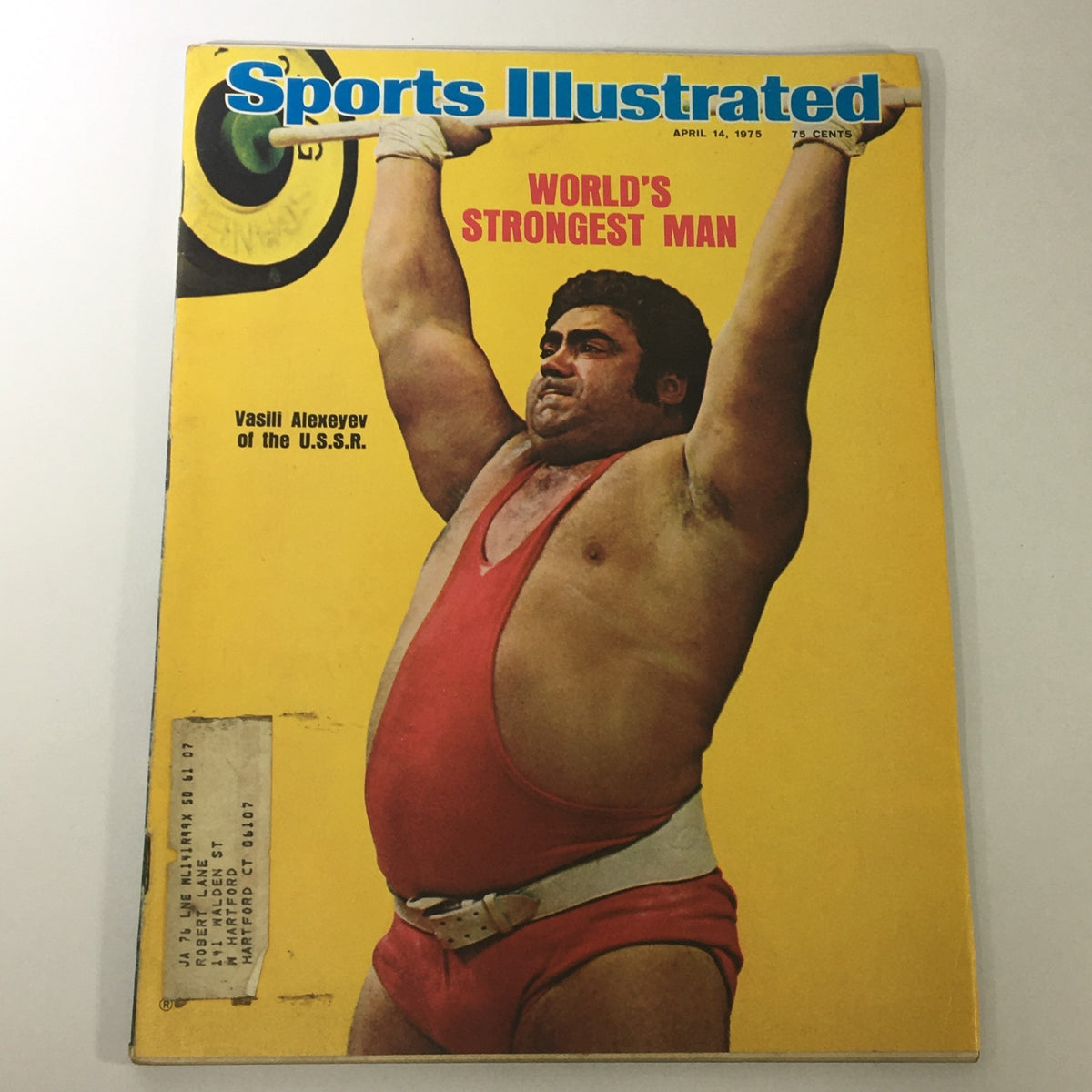Vintage Sports Illustrated magazine cover from April 14, 1975, featuring Vasili Alexeyev as the world's strongest man. The cover displays an action shot of Alexeyev lifting weights, highlighting strength and athleticism in the sport.