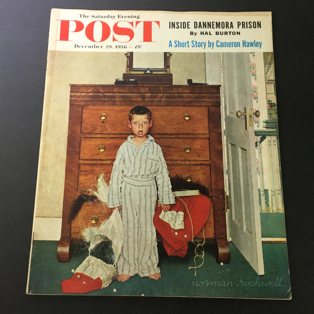 VTG The Saturday Evening Post December 29 1956 Norman Rockwell cover featuring a startled boy in a striped pajama, standing by a dresser with his toys scattered on the floor.