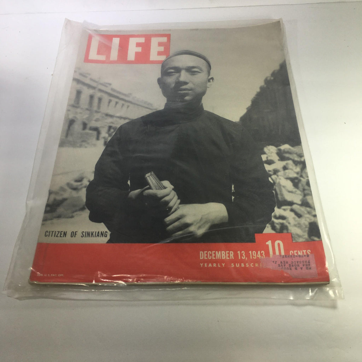 Life Magazine cover from December 13, 1943 featuring the article 'Citizen of Sinkiang'. The cover depicts a man in traditional attire standing amidst a historical backdrop, showcasing the rich culture and history relevant to the issue.