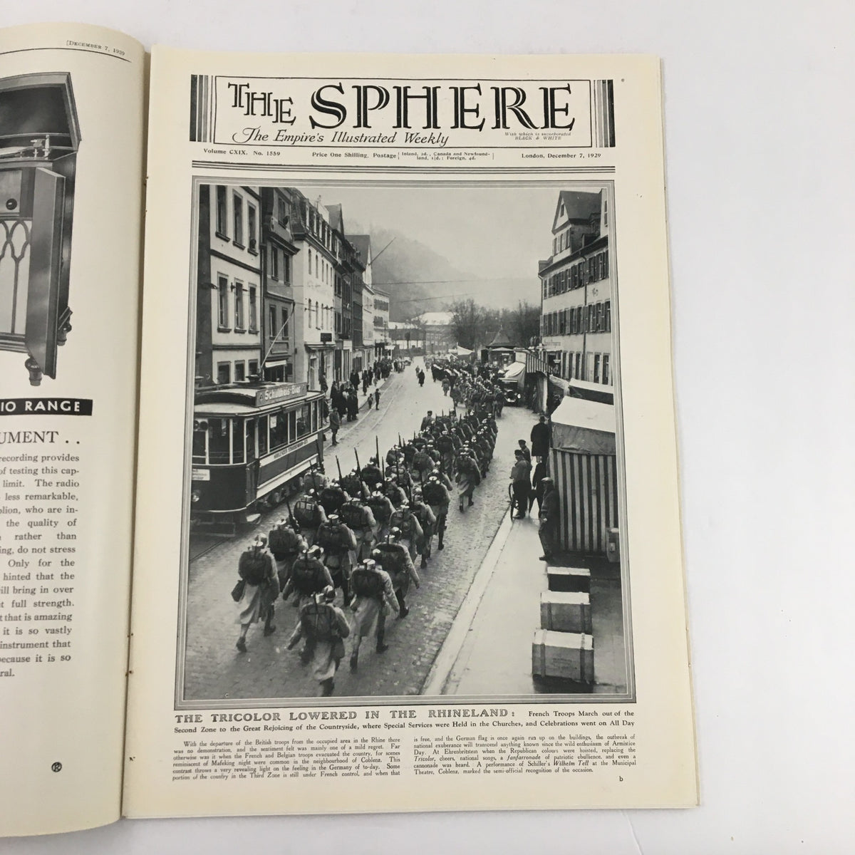 The Sphere Newspaper Cover from December 7, 1929, featuring the headline 'The Tricolor Lowered in The Rhineland' and a historical photograph depicting soldiers marching in a town setting.
