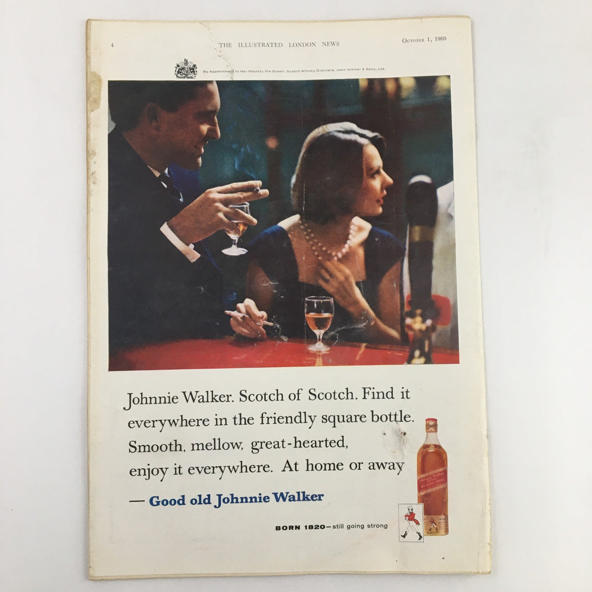 The Illustrated London News October 1 1960 advertisement for Johnnie Walker Scotch showcasing a stylish couple enjoying drinks, emphasizing the smoothness and social versatility of the brand.