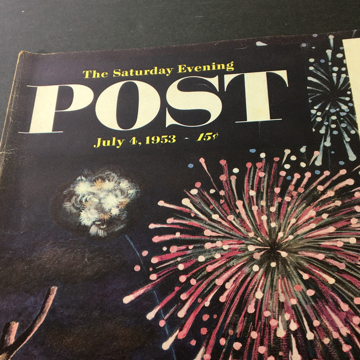 Detailed close-up of the cover of VTG The Saturday Evening Post July 4 1953, highlighting the title and vibrant fireworks.