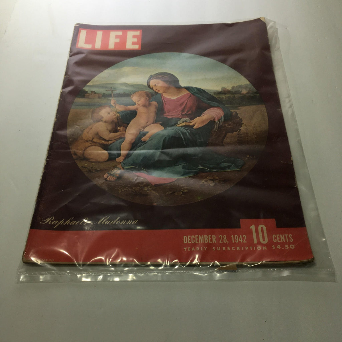 Cover of Life Magazine dated December 28, 1942 featuring Raphael's Madonna. The magazine showcases an iconic artwork, reflecting historical and cultural sentiments of the era with a vintage aesthetic.