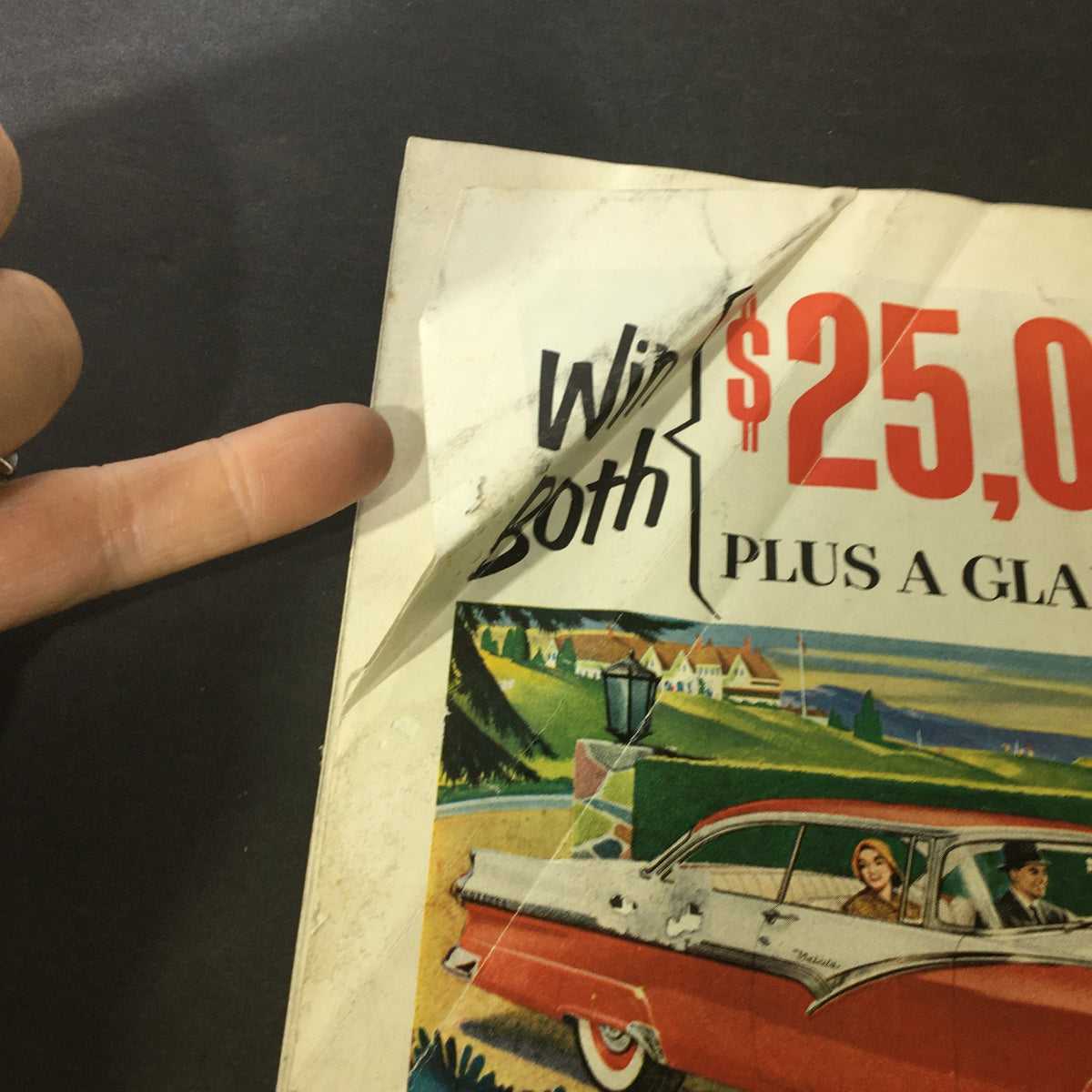 Vintage magazine cover of The Saturday Evening Post dated January 28, 1956, featuring a fold on the top corner, promoting a contest to win $25,000, alongside a stylized illustration of a classic car with people inside.