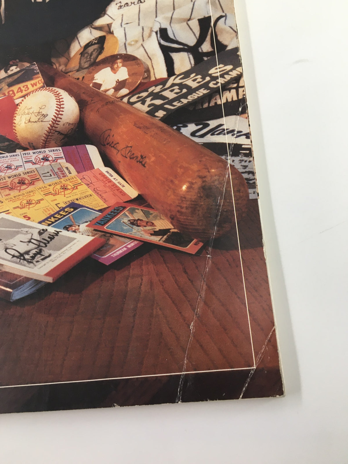 1989 Official Yearbook New York Yankees Reggie Jackson, Hensley Meulens No Label - Close-up of the yearbook cover showing a baseball bat and various Yankees collectibles.