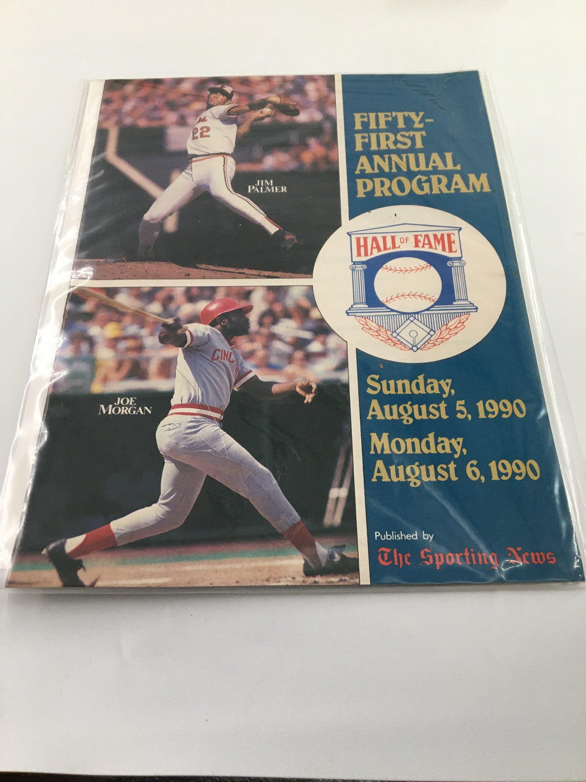Cover of the 1990 The Sporting News Fifty-First Annual Program showcasing baseball legends Jim Palmer and Joe Morgan, highlighting a significant event in Major League Baseball history.