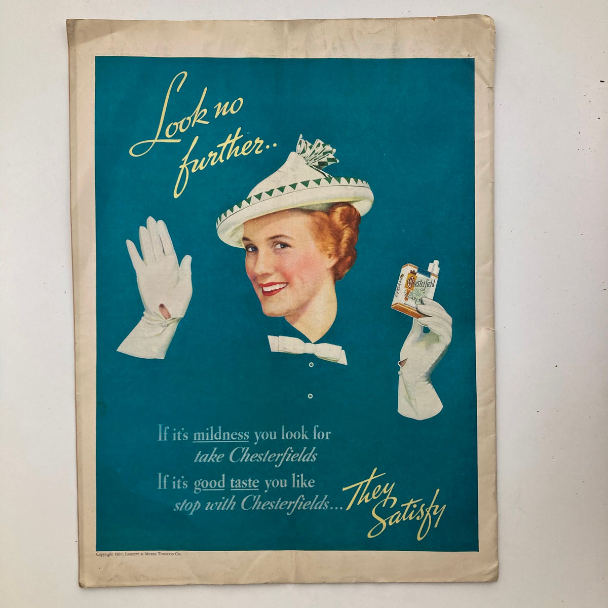 Back cover of VTG Columbia Magazine August 1937 Vol 17 No. 1 featuring an advertisement for Chesterfield cigarettes with a smiling woman in a stylish hat, showcasing vintage advertising design.